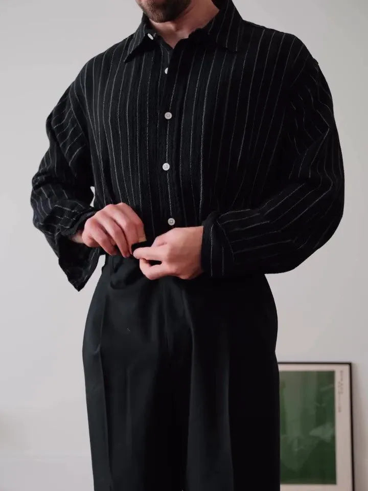 Black pinstriped polyester button-down shirt with regular fit on hanger