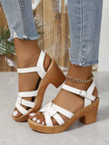 Plus size women's black peep toe sandals with a chunky heel and an ankle-strap buckle closure.