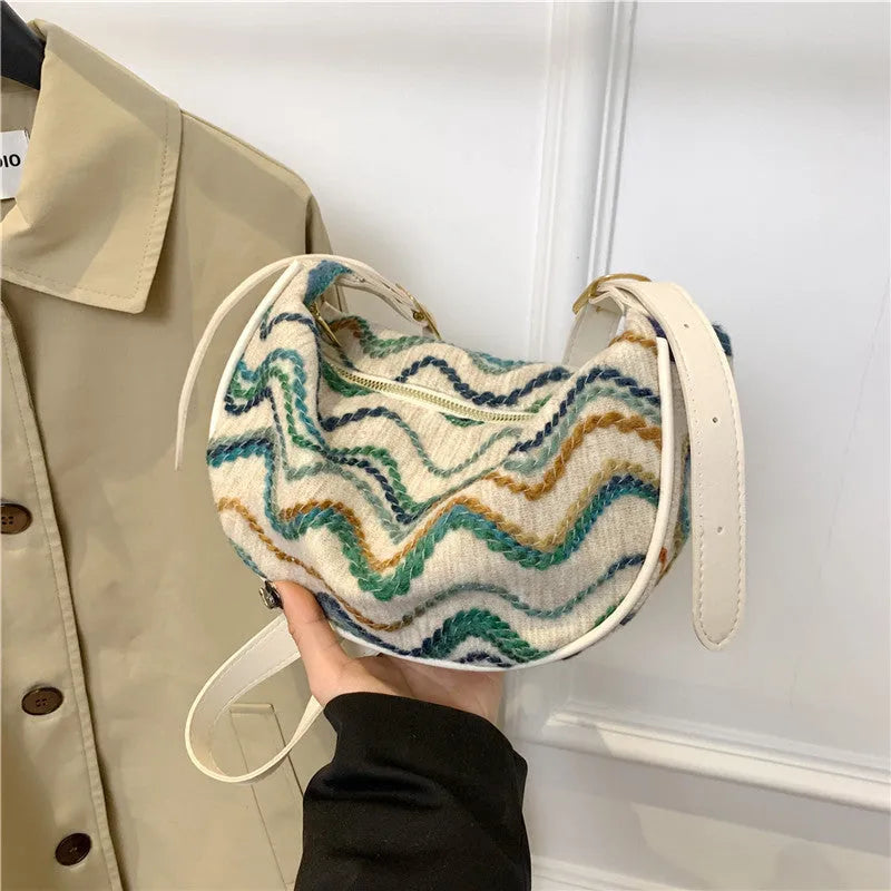 Women's straw woven crossbody bag showing internal phone and file compartments