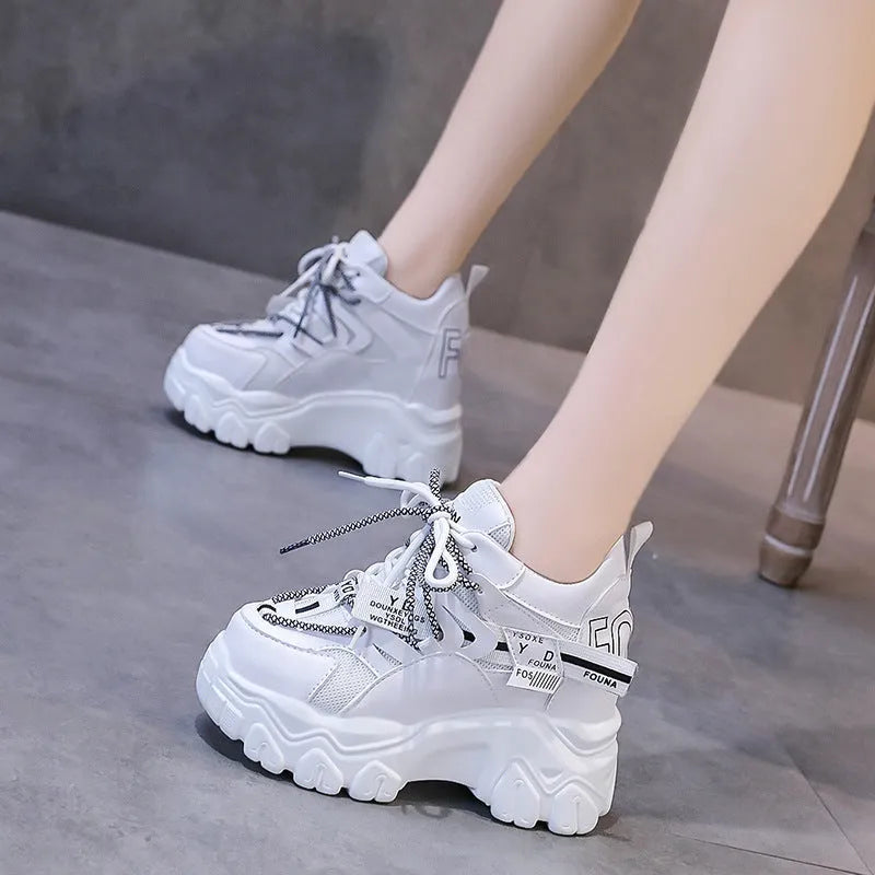 Women's white and black mesh platform sports shoes with cross-strap design and rubber sole