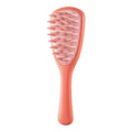 Purple pet silicone shampoo brush with handle on a wet dog coat, designed for gentle bathing and hair removal