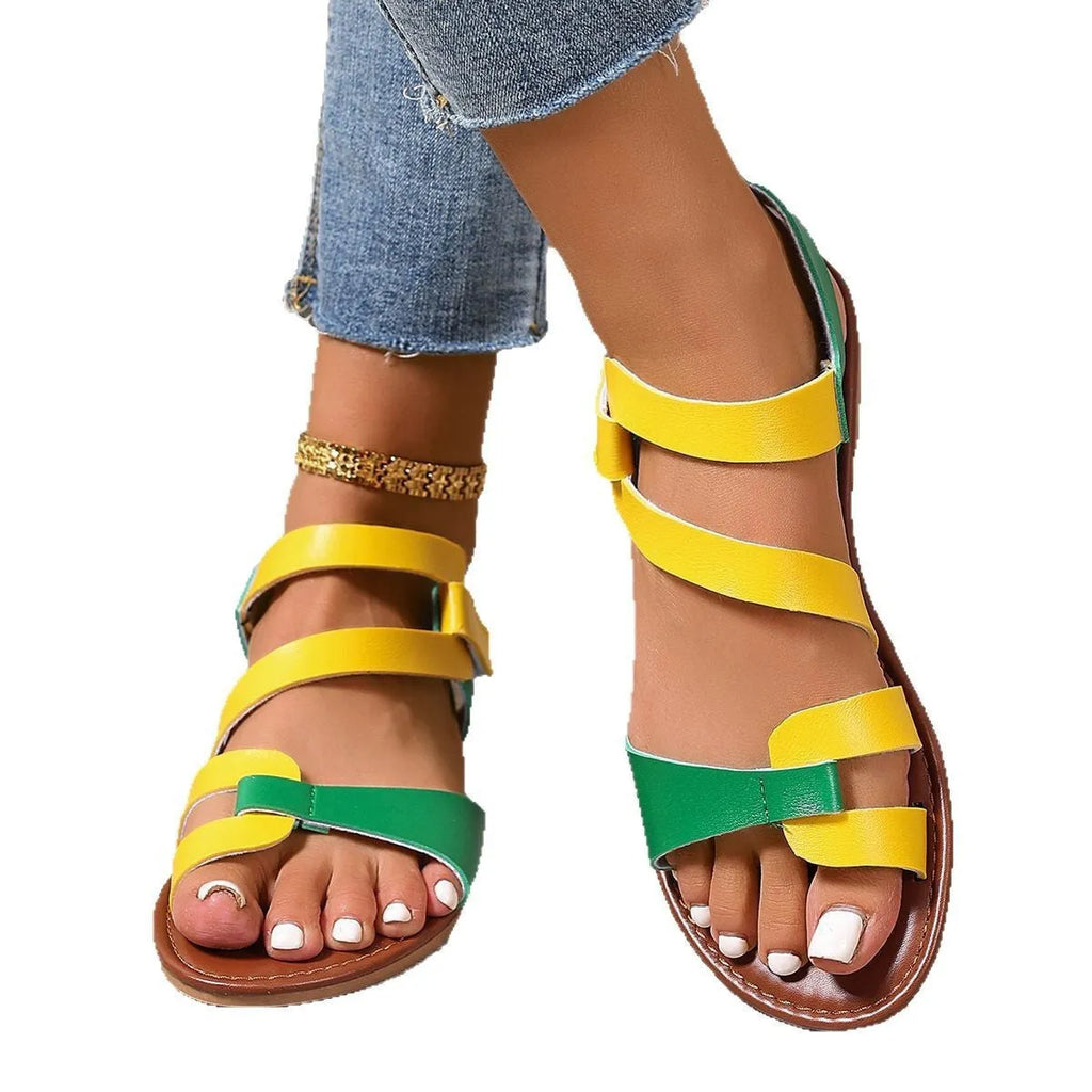 Women's flat sandals with Velcro strap, round toe, and rubber sole in black, brown, or colourful.