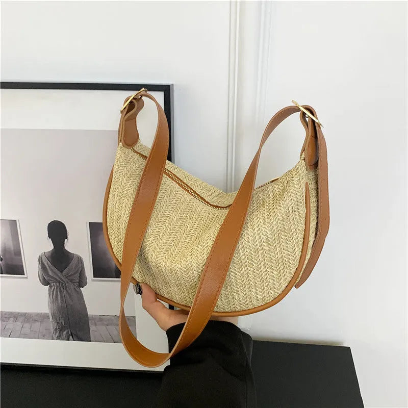 Women's straw woven crossbody bag showing internal phone and file compartments