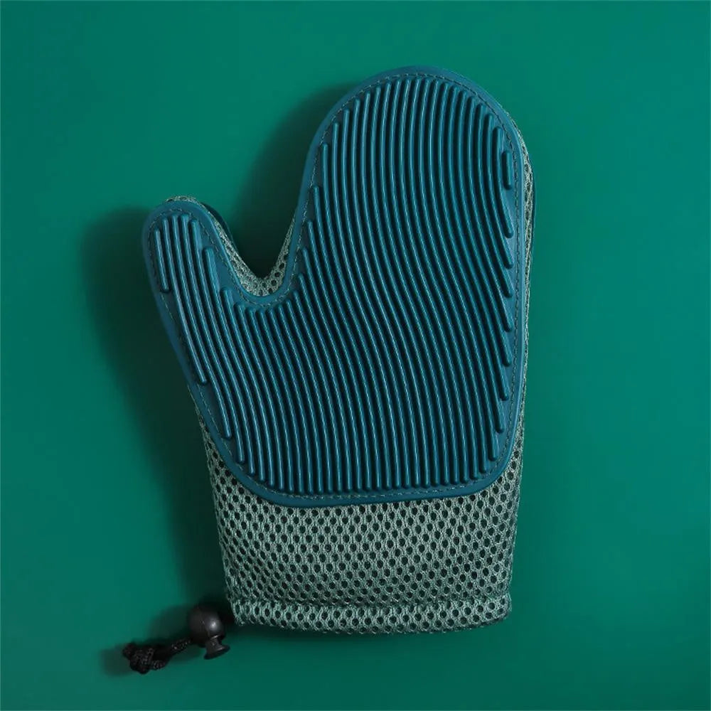Dark blue pet hair removal grooming glove for right hand on a fabric sofa.