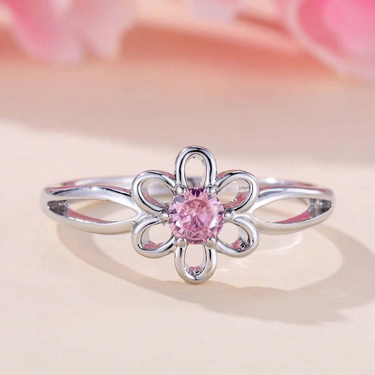 Women's hollow floral ring made from copper with electroplated finish in platinum pink diamond colour