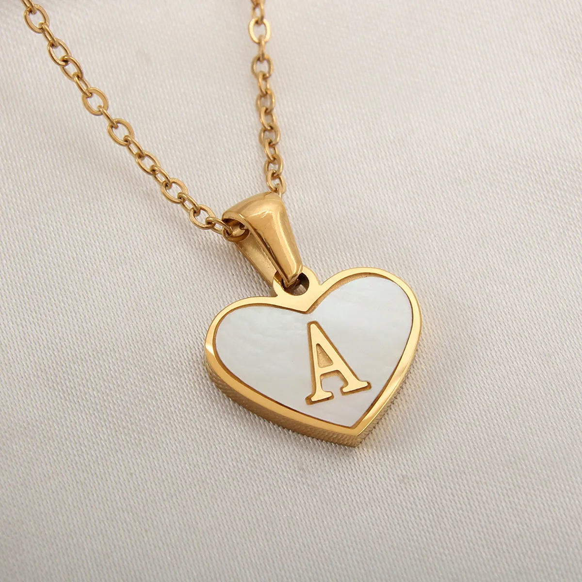 Gold heart necklace with white shell pendant and initial charm on 45cm adjustable chain