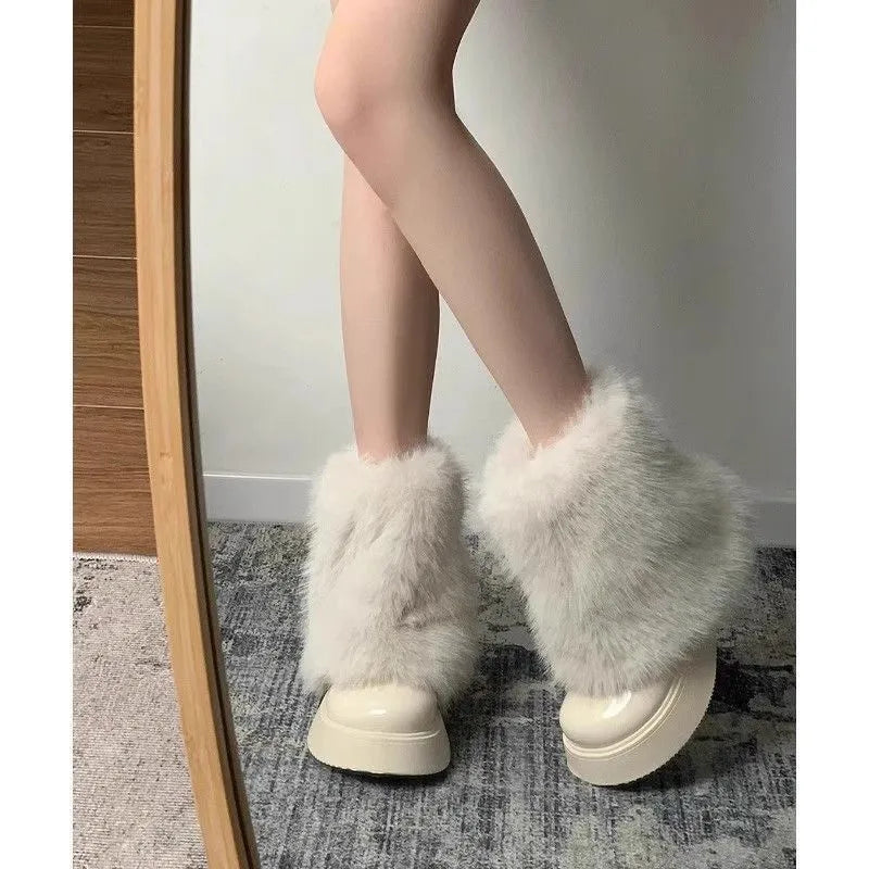 Women's black fleece-lined low-top snow boots with a round toe, waterproof platform, and a mid-height heel on a rubber sole.