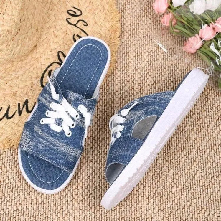 Blue women's flat canvas roman slippers with cloth lining and a rubber sole.
