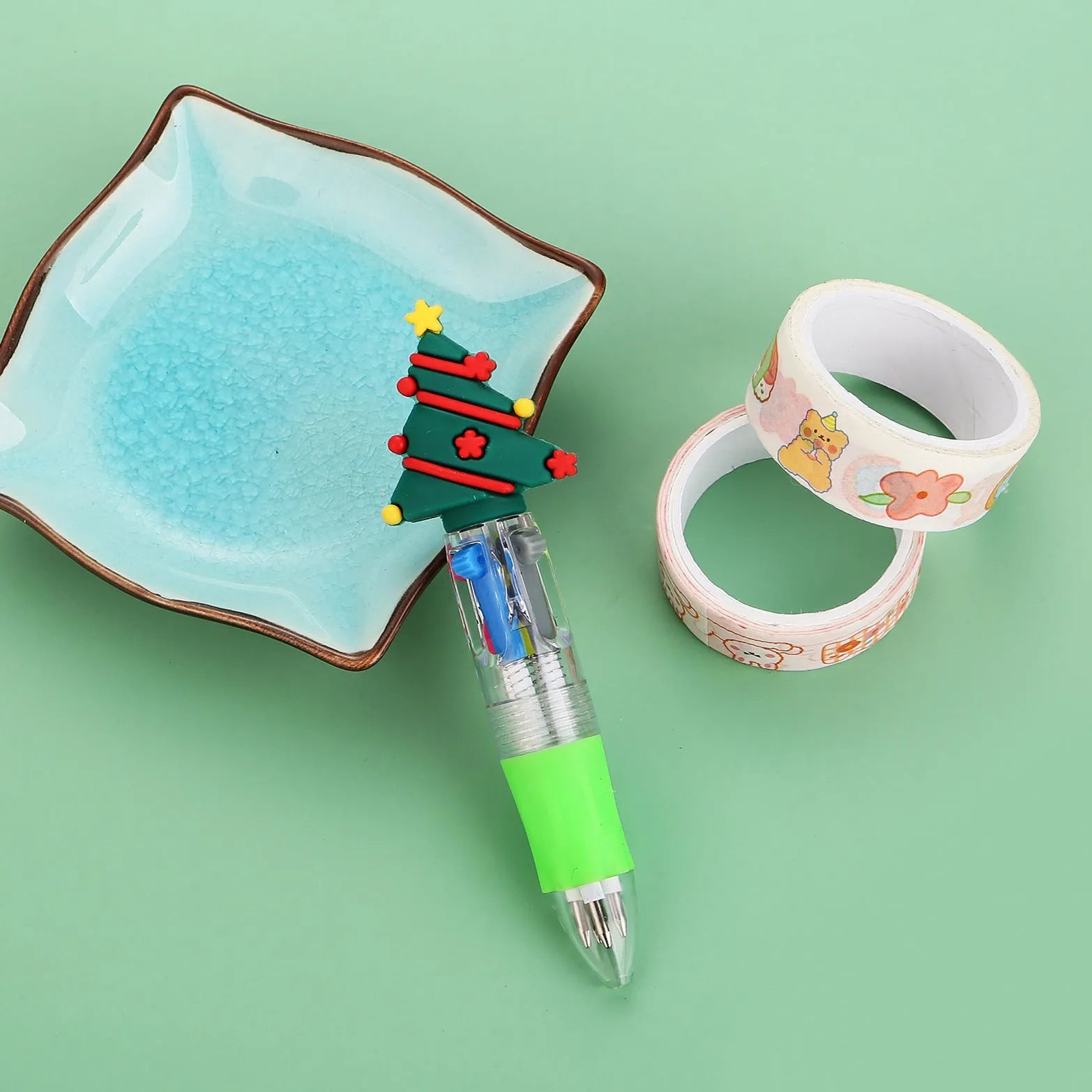 Christmas mini four-colour press-type ballpoint pen showing festive designs, 11cm long.