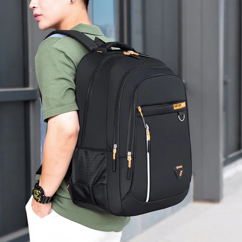 Men's Oxford cloth schoolbag in black with letter pattern, showing large capacity and air pillow shoulder straps.