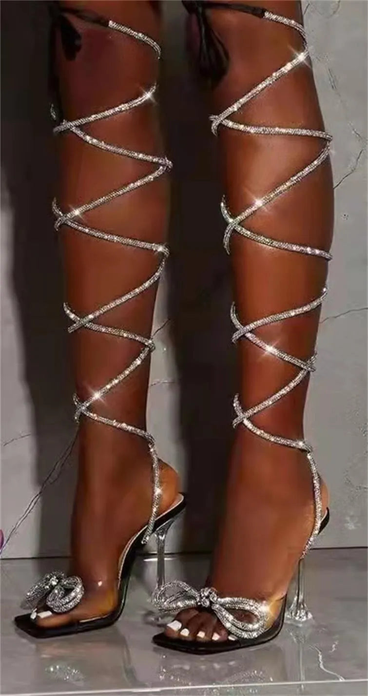 Plus size women's black strappy sandals with rhinestone decorations and a square toe.
