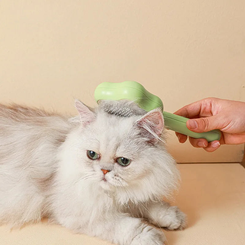 Green self-cleaning cat comb with stainless steel needles measuring 20 cm long