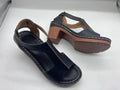 Women's white peep toe wedge sandals with a Roman style fish mouth toe and ankle buckle on a low rubber sole.