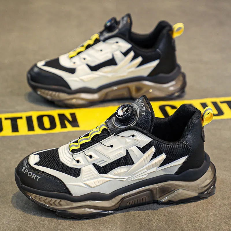 Men's black casual shoes with rotating button fastener and mesh upper on a rubber platform sole.