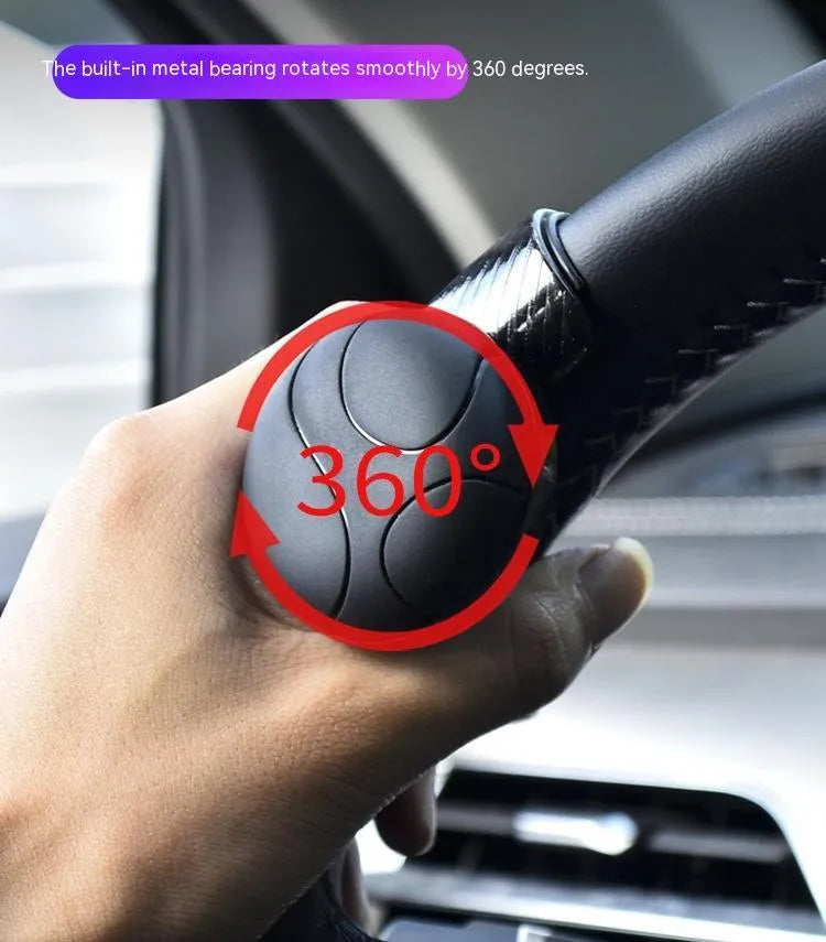 Silicone steering wheel assist ball with metal bearing in black or blue colour, approximately 9cm by 6cm