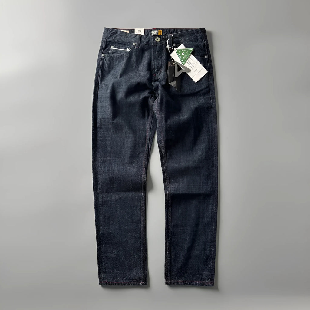 Men's primary blue straight-leg cotton denim trousers on a neutral background, showing mid-waist fit and trouser length.
