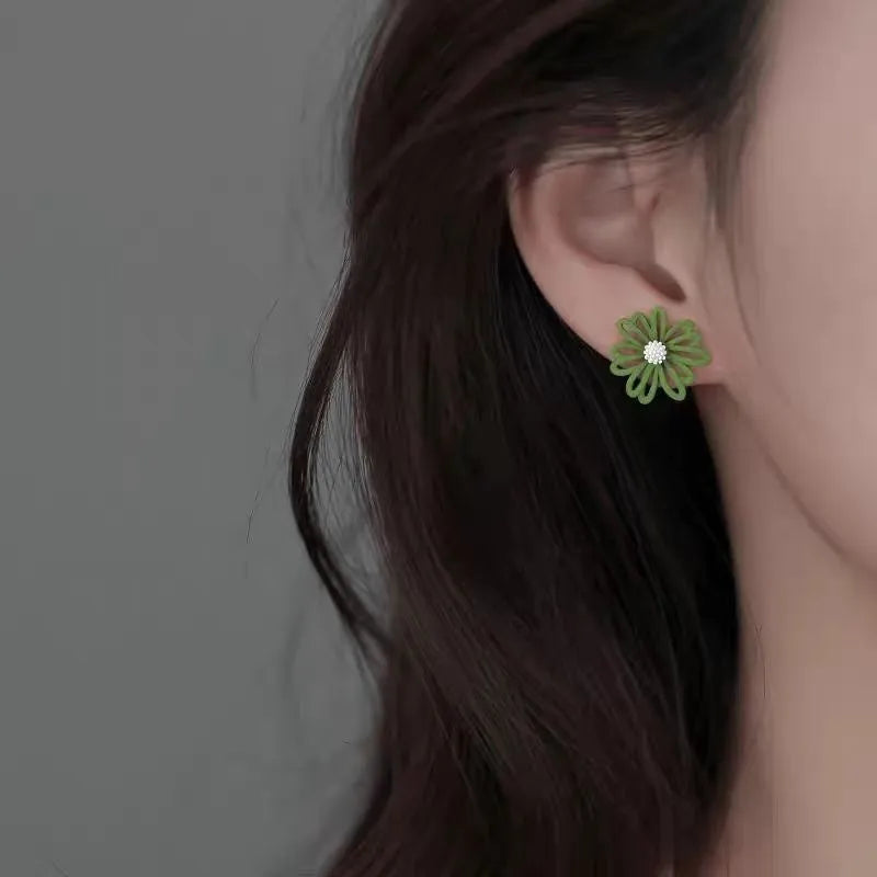 Alloy flower-shaped stud earrings in two-tone blue orange, white green, and yellow white colour combinations.