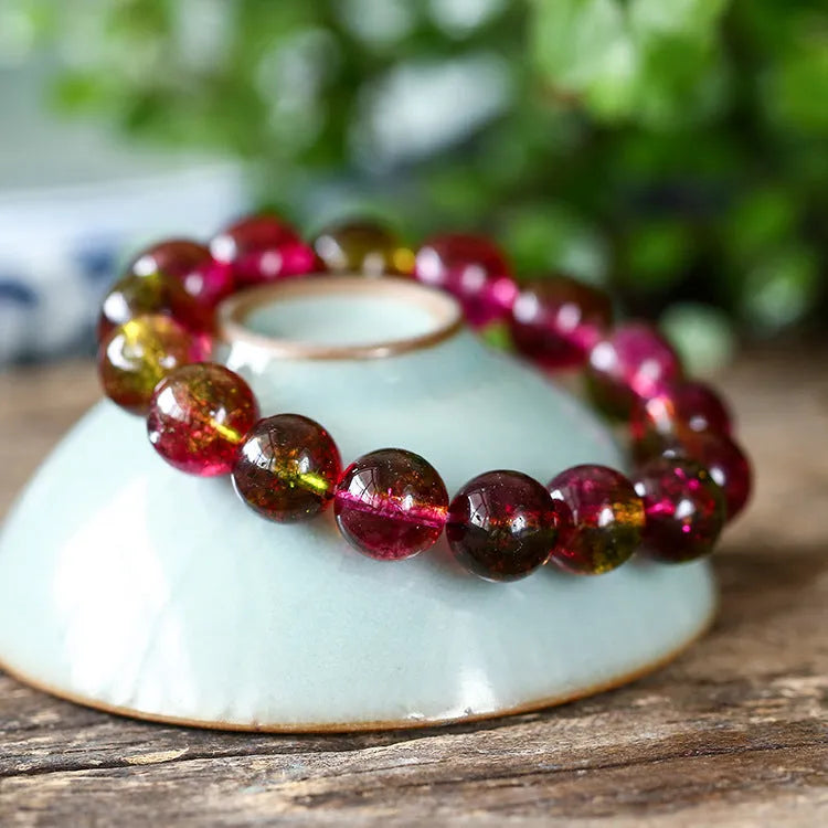 Women's watermelon-coloured crystal bracelet with pastoral design, shown in different size options.