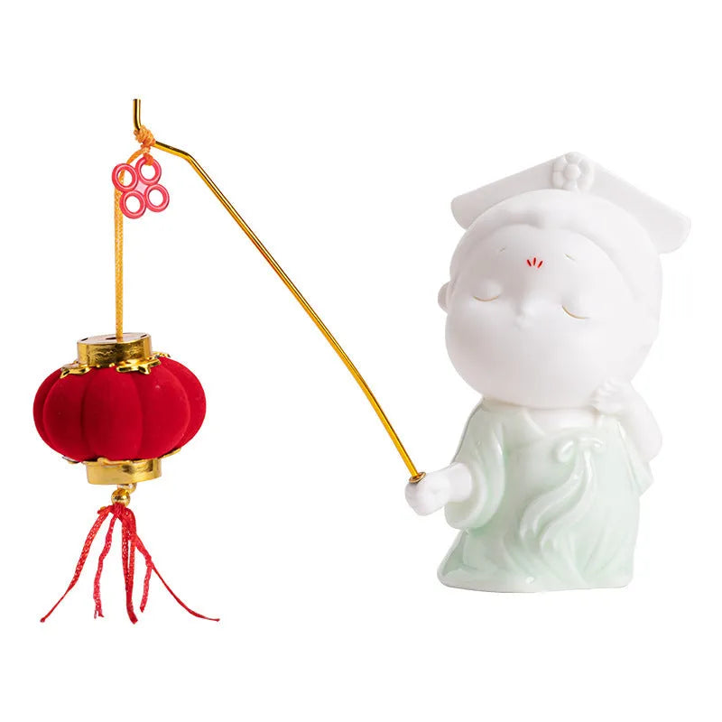 Ceramic cute female court attendant incense burner decoration in hand-painted colours on a shelf.
