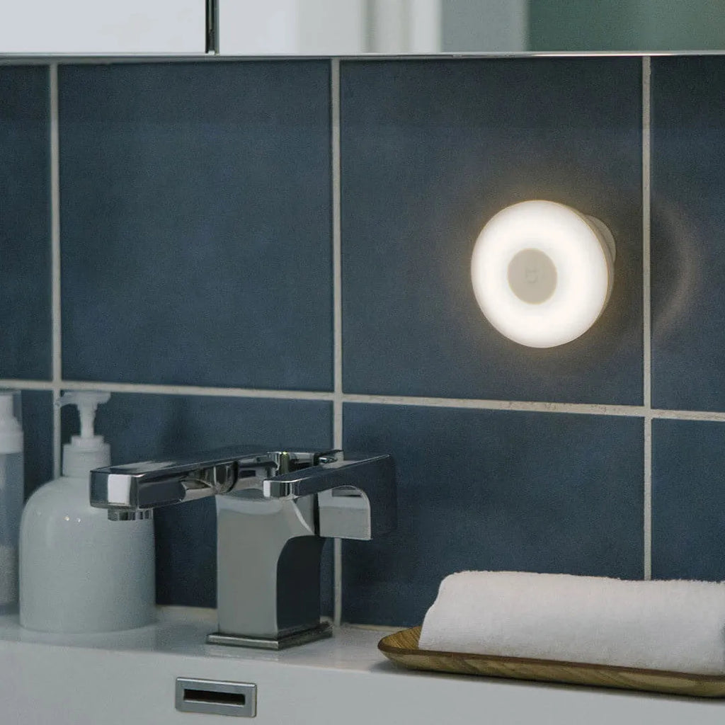 White modern bedside table lamp with Bluetooth and body induction sensor.