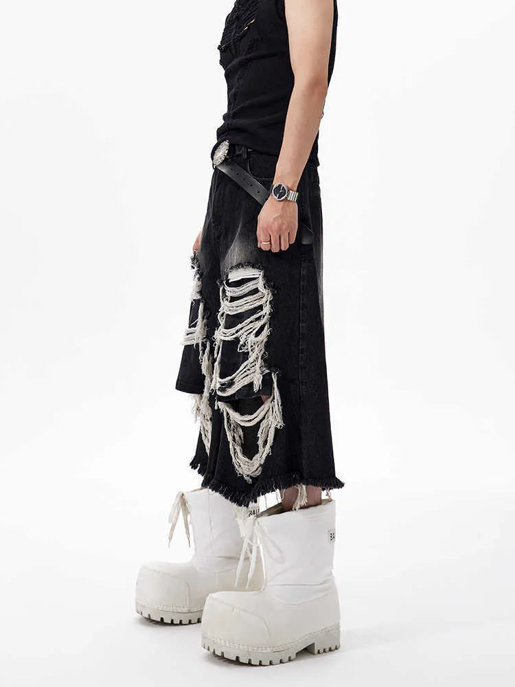 Black cropped wide leg jeans with mid-high waist and ripped patch detail on a loose fit.