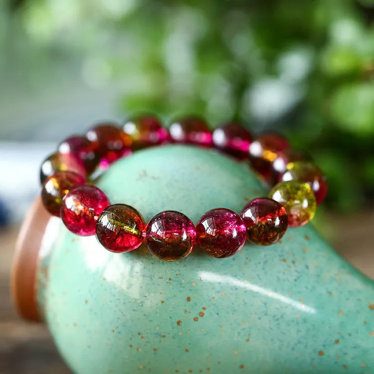 Women's watermelon-coloured crystal bracelet with pastoral design, shown in different size options.