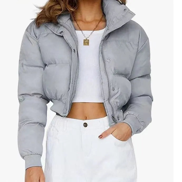 Loose fit blue polyester jacket for women on a hanger, showing long sleeves and front closure.