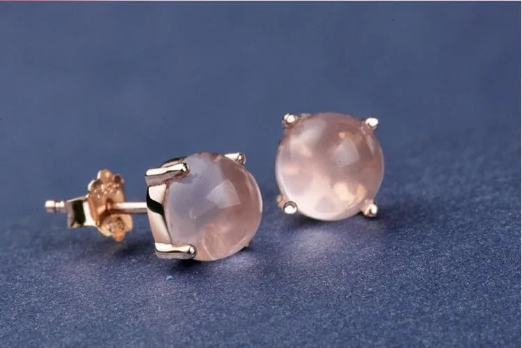 Rose gold drop-shaped stud earrings with crystal inlay detail.