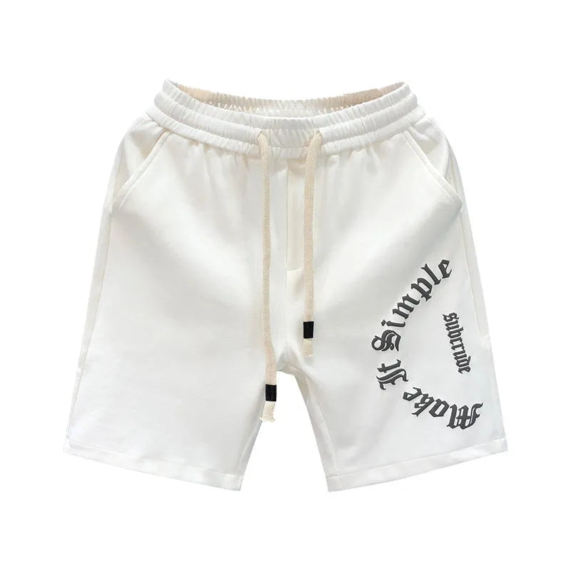 Printed cropped polyester sports pants in black for teenage men, side view showing cropped leg length