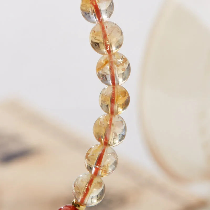 Hand-woven citrine five sutra bracelet with 6mm crystal beads showing geometric patterns