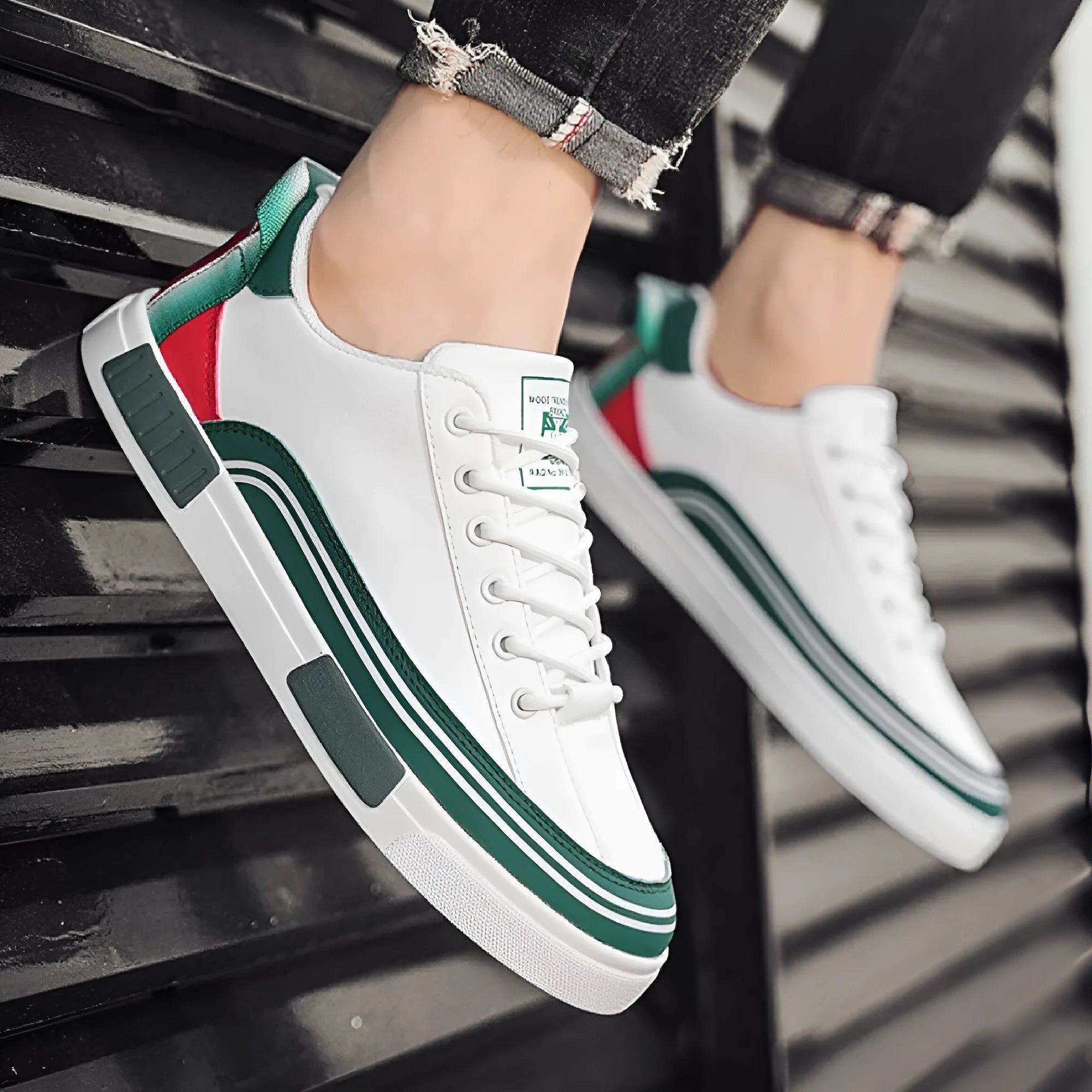 Men's white and green canvas casual shoes with mesh ventilation panels on the upper.