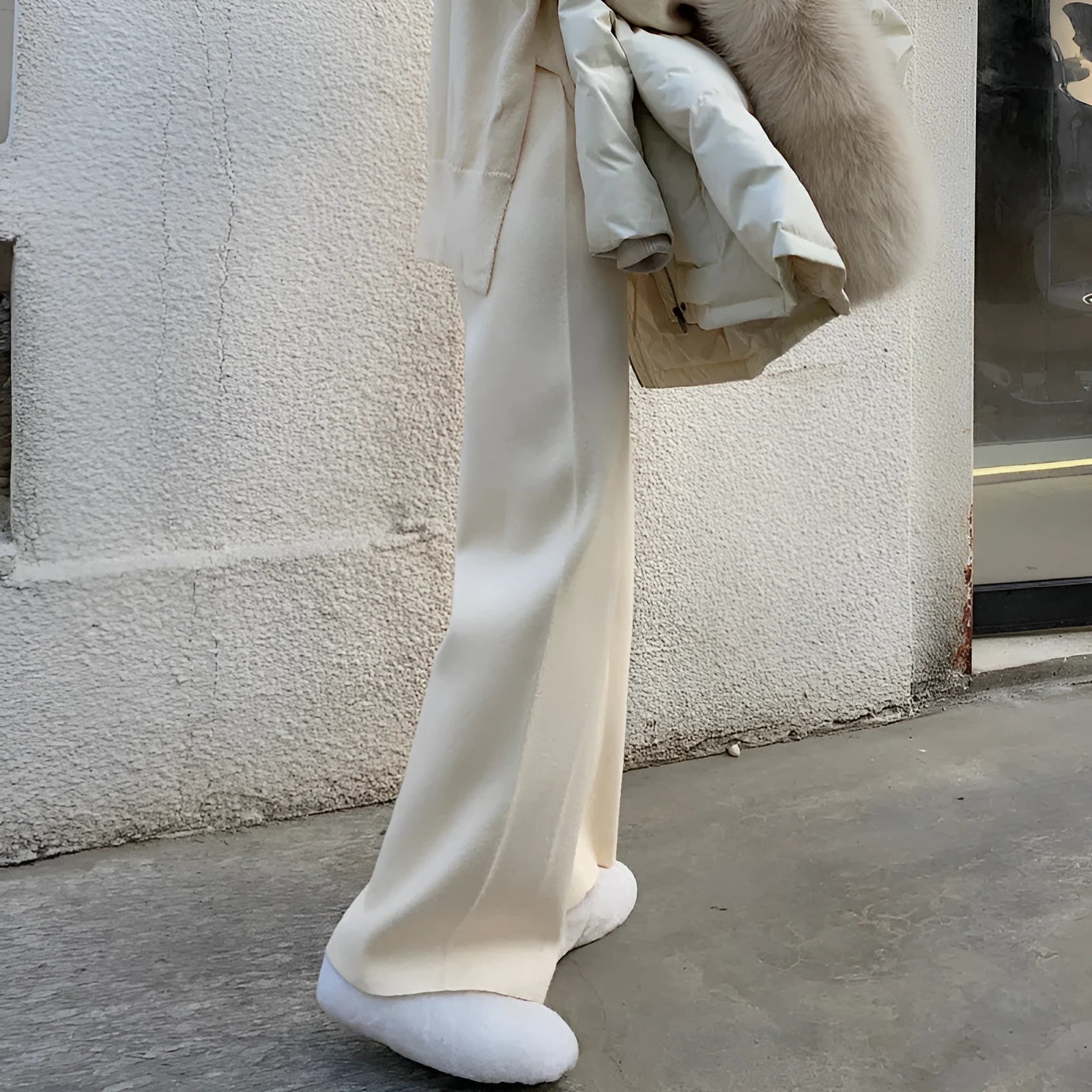 Women's high waist knitted wide-leg trousers in cream white colour with dropped mopping style