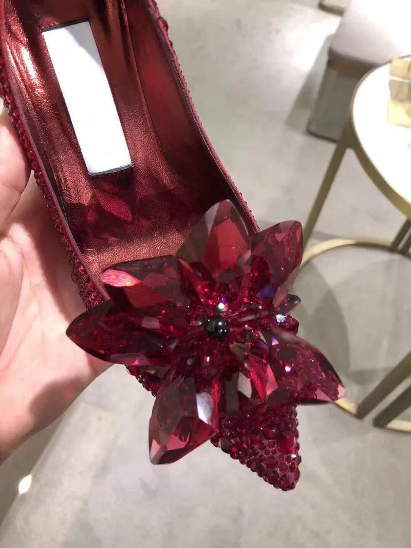 Women's gold pointed toe stiletto high heels with sequin cloth and rhinestone decoration.