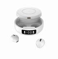 Mini black and white semi-in-ear wireless headphones sitting in their open wireless charging case.
