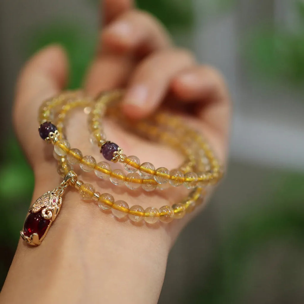 Natural Brazilian gold rutilated quartz bracelet with three circles and hanging chopsticks design