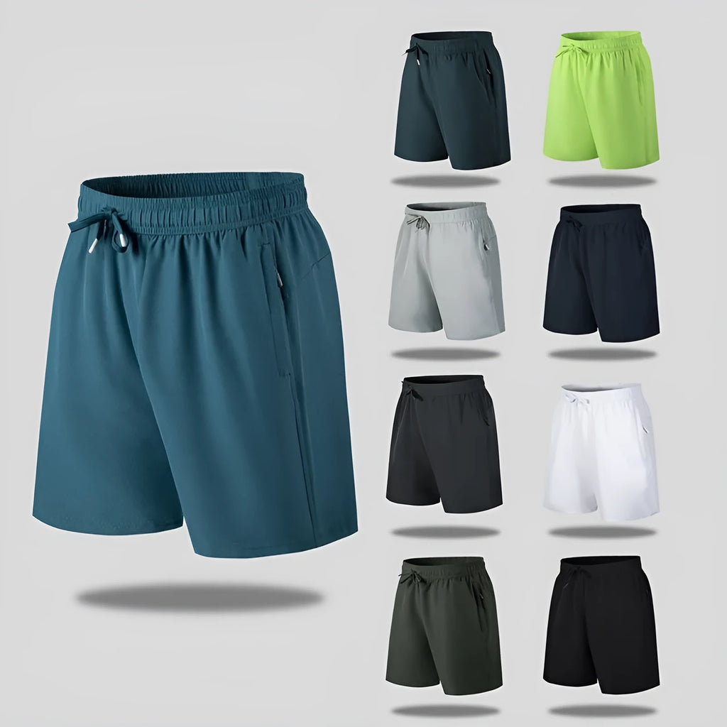 Man wearing loose fit black quick-dry ice silk sports shorts on a beach.