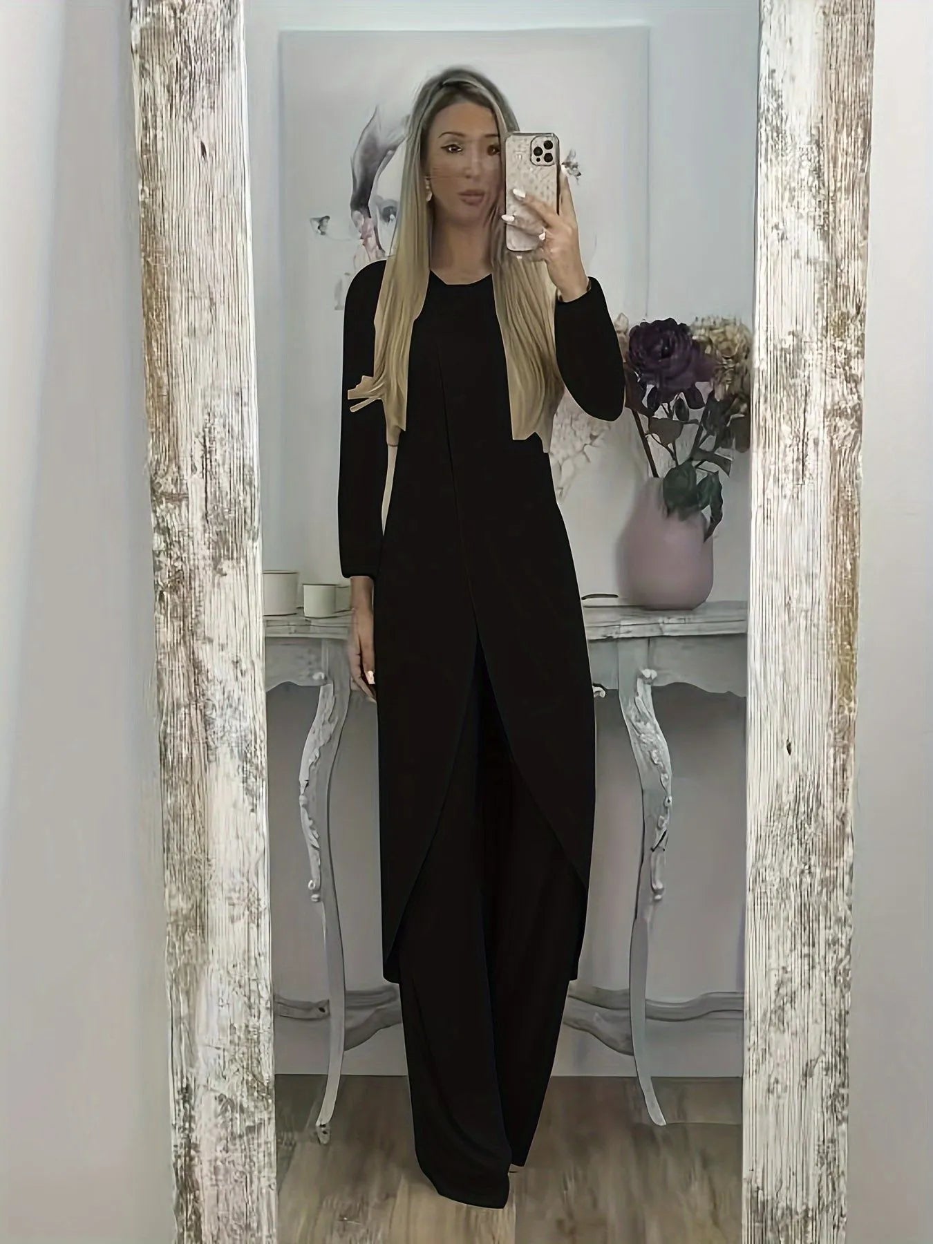 Casual long sleeve polyester two-piece lounge set in black, shown with loose round neck top and trousers.