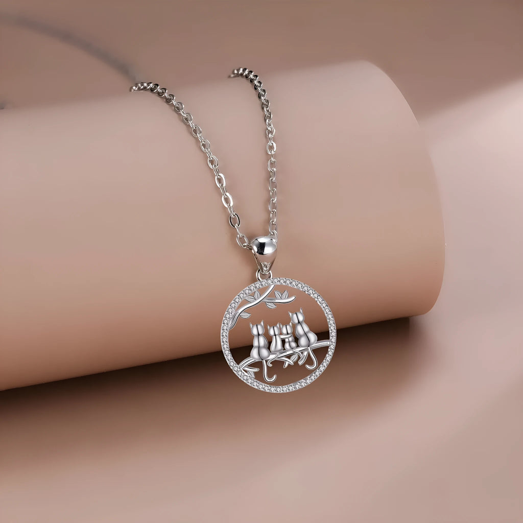 Women's copper necklace with a four kitten pendant on a cross chain, electroplated finish.