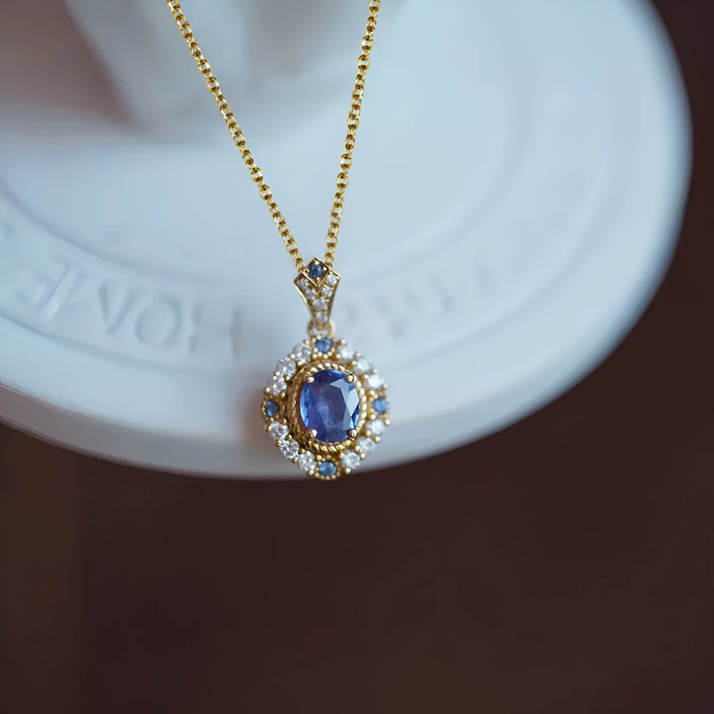 Yellow gold royal necklace with mixed gem inlaid pendant on a copper box chain, adjustable length.