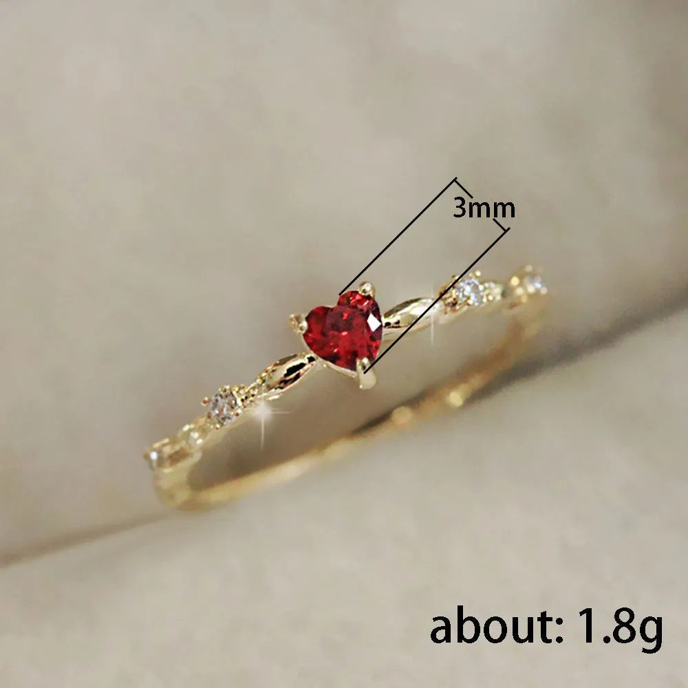 Gold or silver colour peach heart shaped ring with zircon stones on a copper band.
