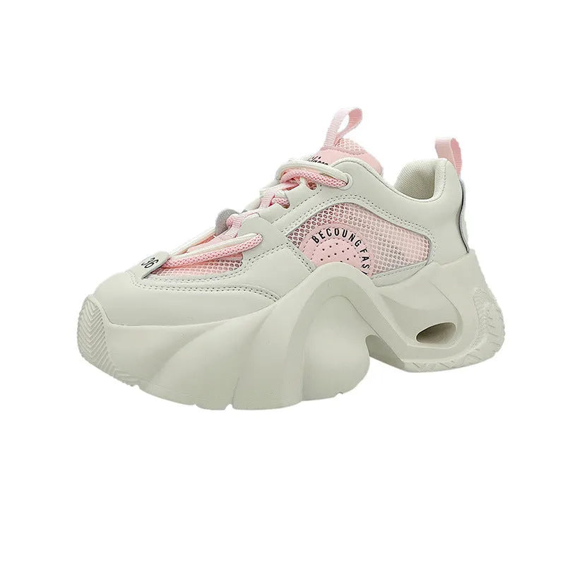 Women's beige sneakers with thick sole, cross straps, and mesh lining.