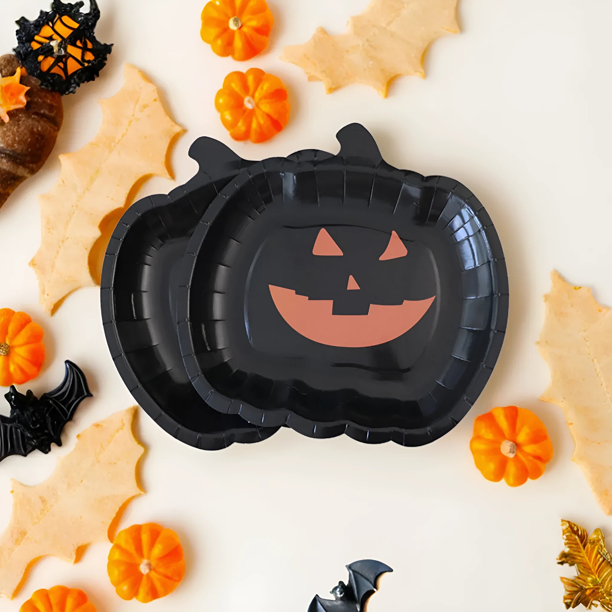 Halloween disposable paper plates with black pumpkin design, 9-inch diameter