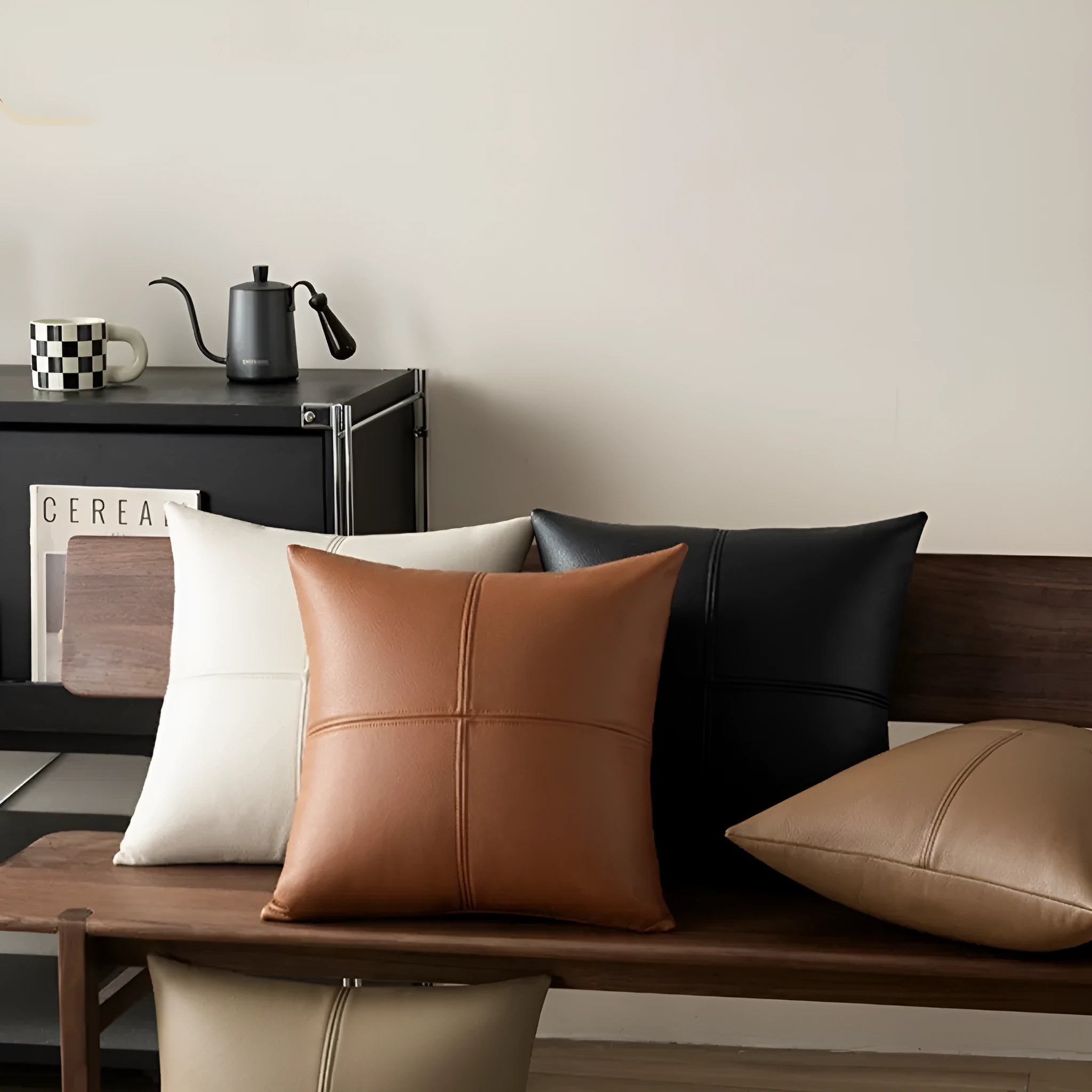 Soft cowhide leather pillow cover in a solid colour, shown in a Nordic style interior setting.