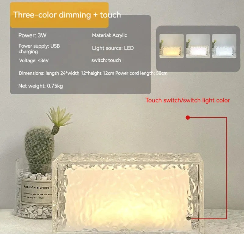 Clear acrylic ice cube shaped night lamp with coloured LED light on a table.
