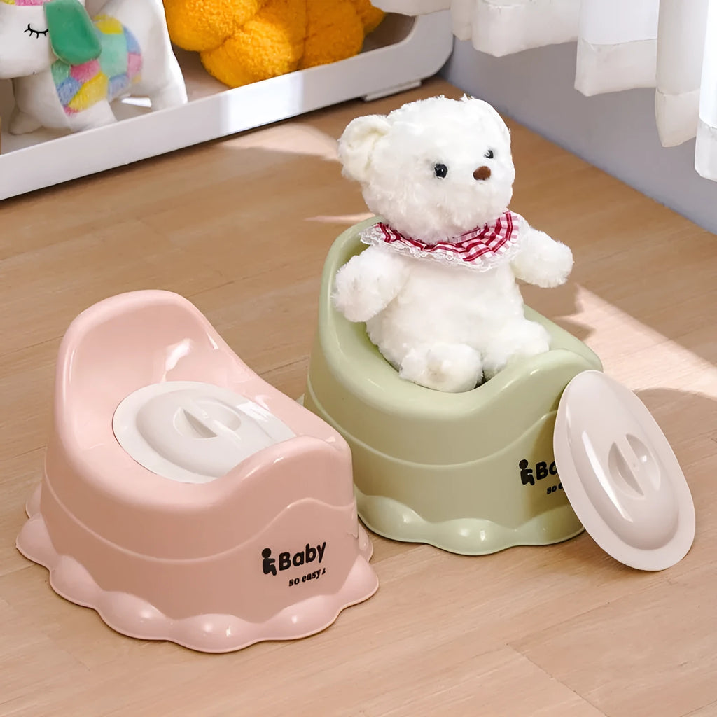 Children's small portable thickened toilet in Green with lid on white background