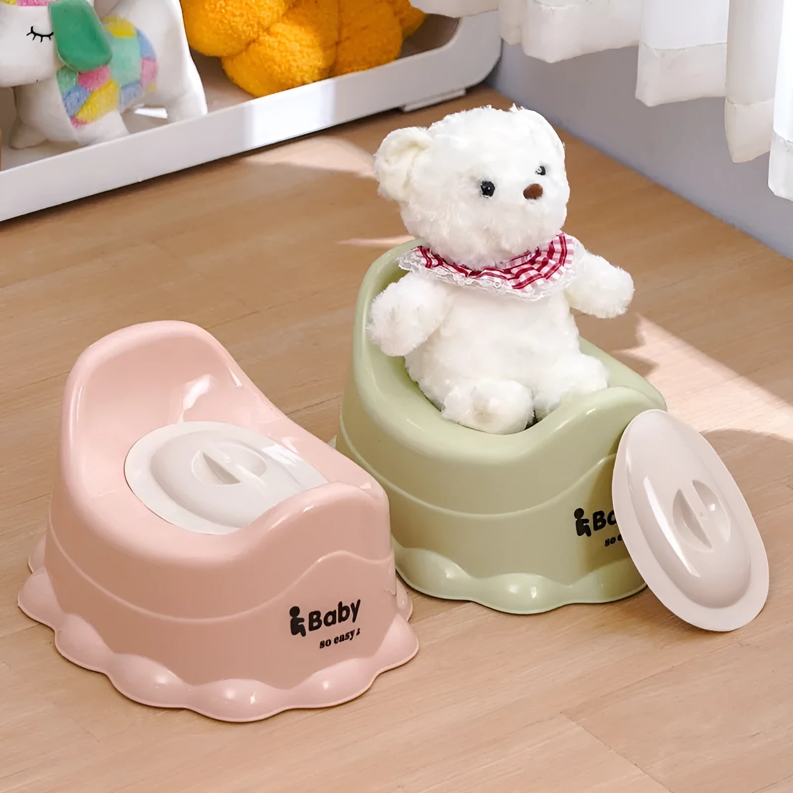 Children's small portable thickened toilet in Green with lid on white background