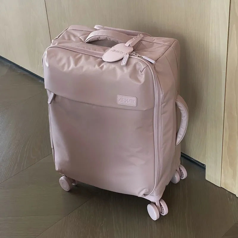 Ultra-light waterproof Oxford cloth suitcase in bluestone green with universal wheels, shown in a 24-inch size.