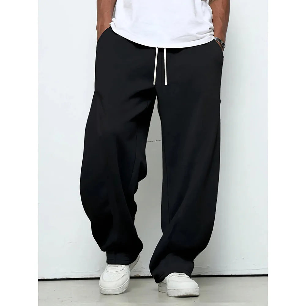 Men's straight-leg casual trousers in polyester with an elasticated waist, shown in black, grey and light grey.