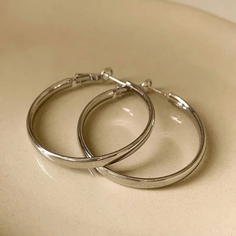 Large 40mm circular metal hoop earrings in gold or silver electroplated finish