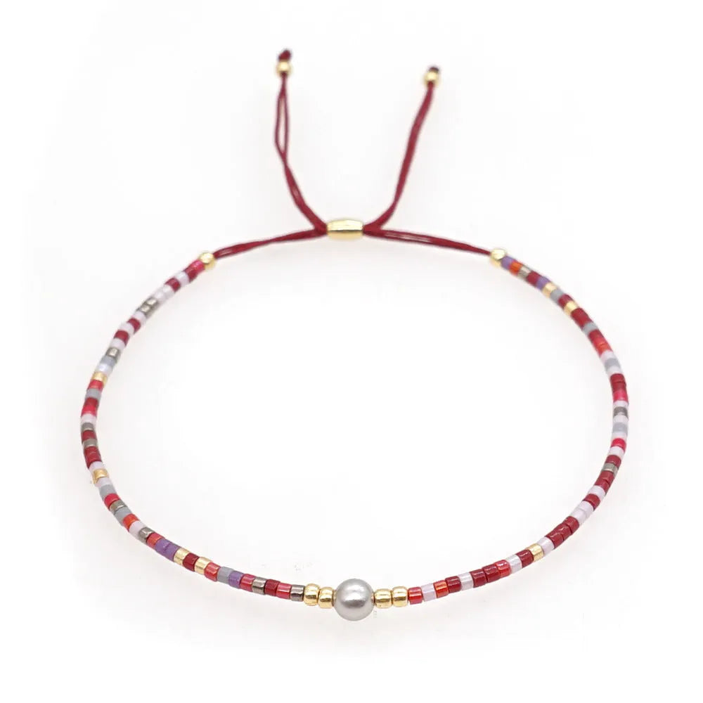 Handmade bohemian style bracelet with colourful geometric glass and coloured glaze beads.